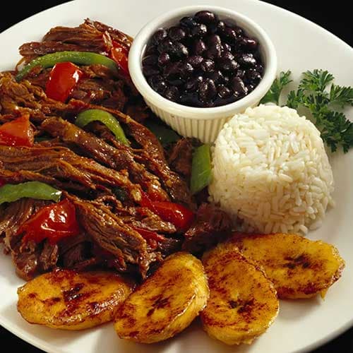 Cuban ropa vieja with rice, black beans, and plantains